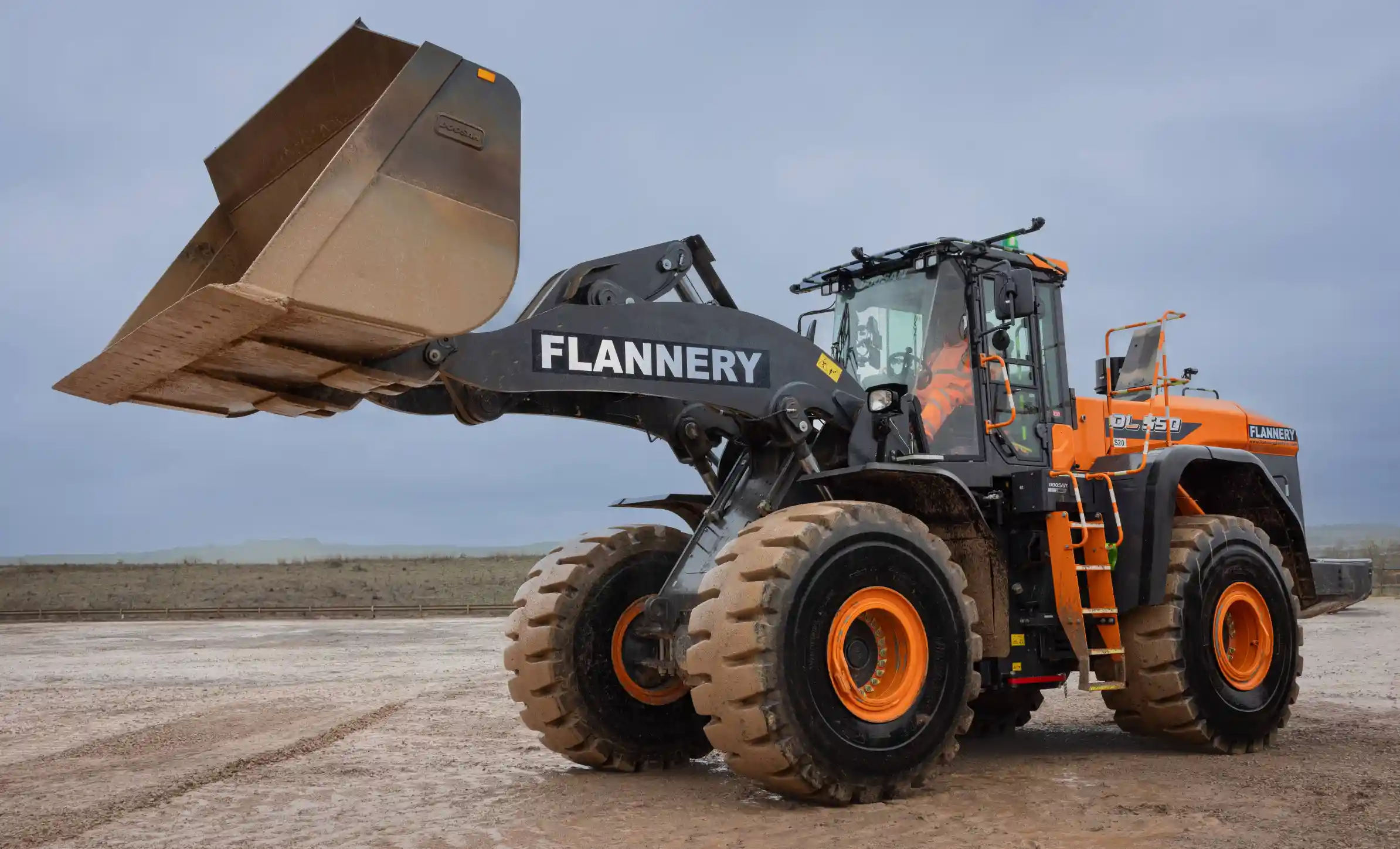 Front loading shovel with the bucket in the air.